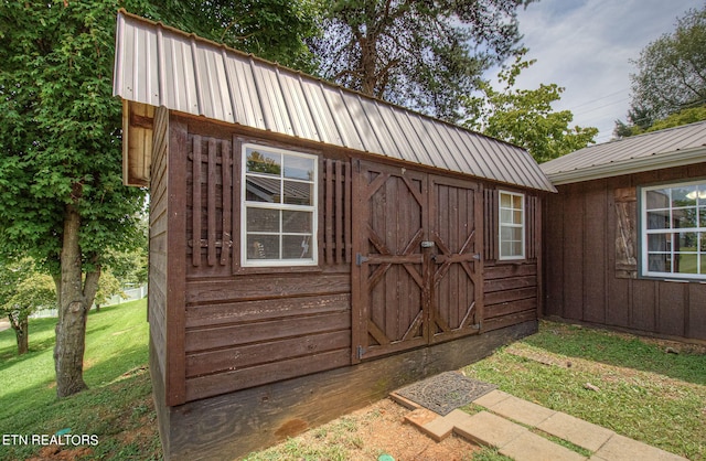 view of outbuilding with a lawn