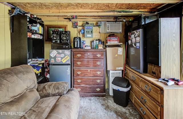 sitting room featuring an AC wall unit and concrete flooring