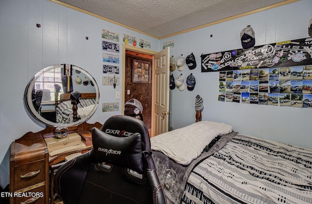 bedroom featuring ornamental molding, a textured ceiling, and wood walls