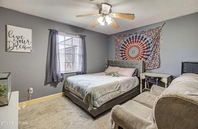 carpeted bedroom featuring a textured ceiling and ceiling fan