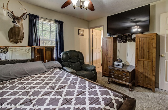 carpeted bedroom featuring a textured ceiling and ceiling fan