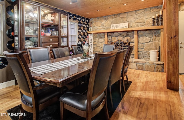 dining space featuring wood-type flooring and wooden ceiling