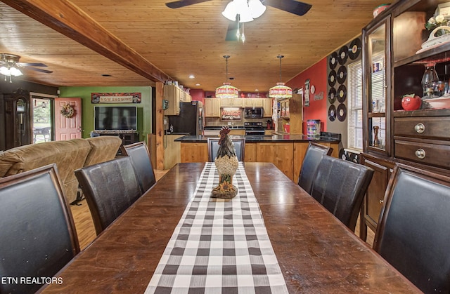 dining room with beamed ceiling, wooden ceiling, and ceiling fan