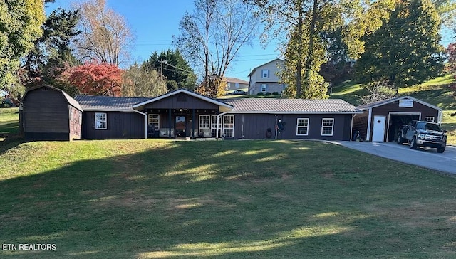 ranch-style house with an outdoor structure, a front yard, and a garage