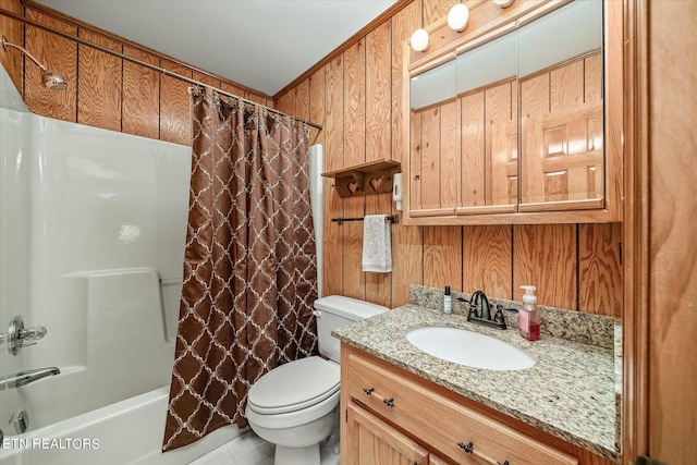 full bathroom with shower / bath combo, vanity, wooden walls, and toilet