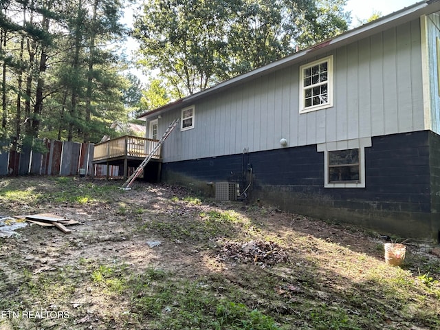 view of side of home featuring central air condition unit and a deck