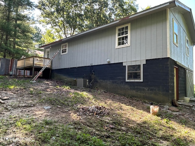 view of property exterior with central air condition unit and a deck