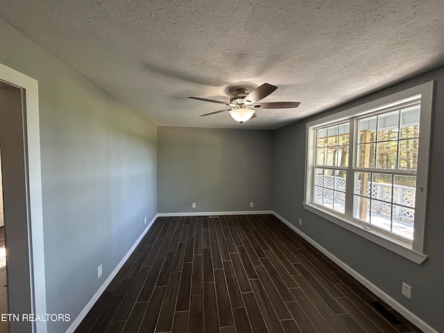 unfurnished room featuring ceiling fan, a textured ceiling, and dark hardwood / wood-style floors