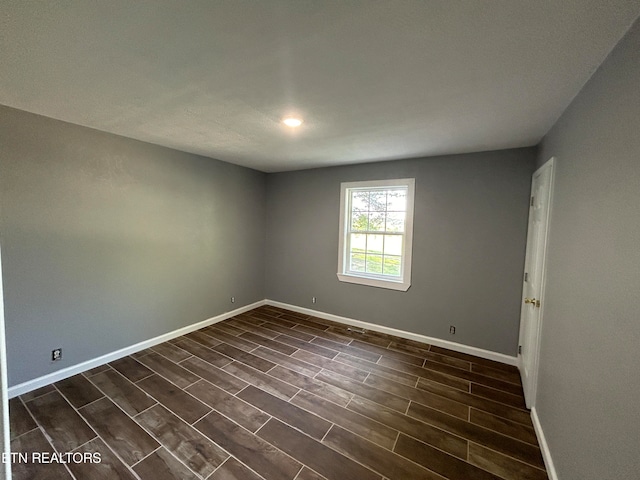 empty room with dark hardwood / wood-style floors