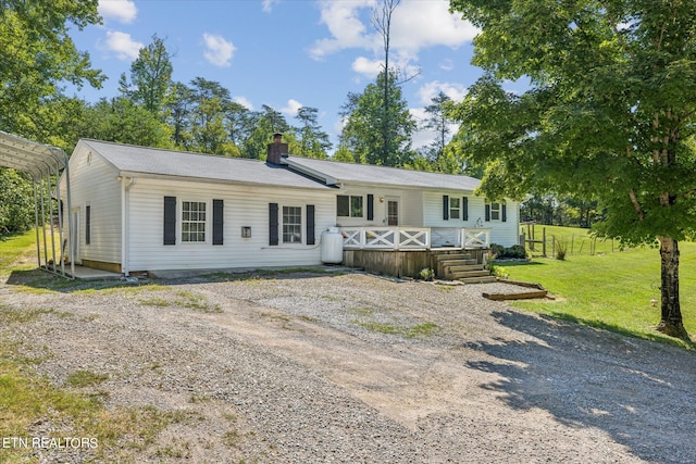 view of front of property with a front lawn and a deck