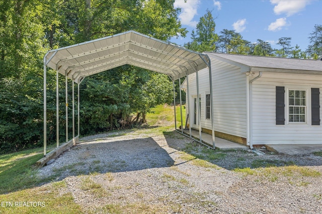 view of parking / parking lot featuring a carport