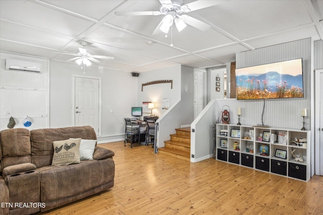 living room with ceiling fan, light hardwood / wood-style flooring, and a wall mounted AC