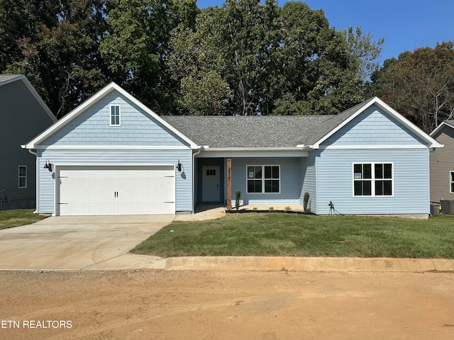 ranch-style home with a garage and a front lawn