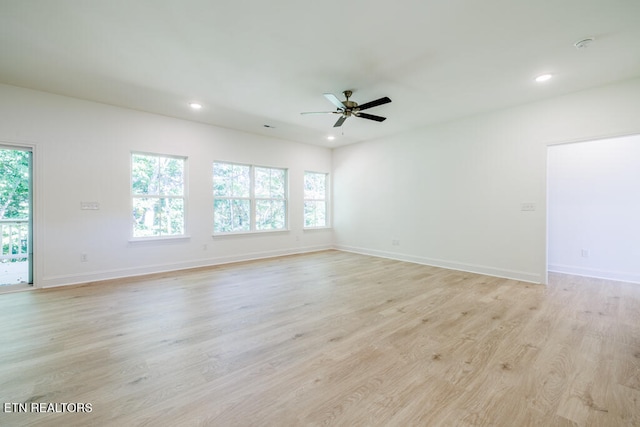 spare room featuring light hardwood / wood-style floors and ceiling fan