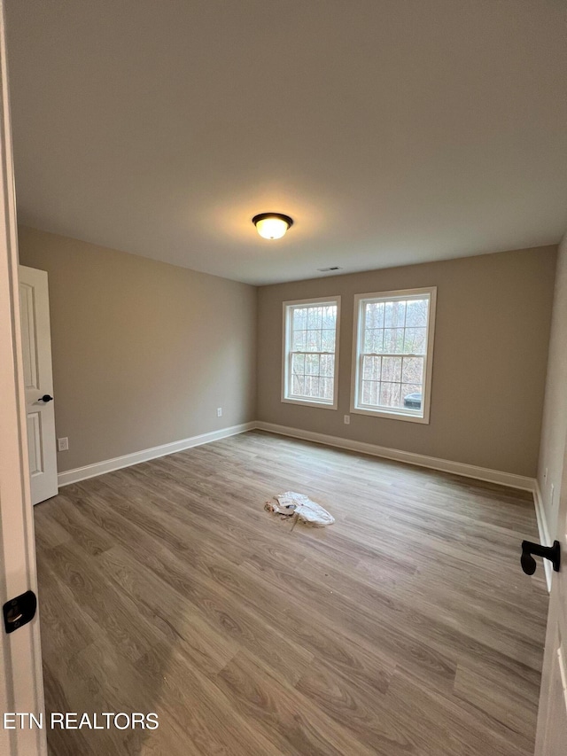 spare room with hardwood / wood-style flooring