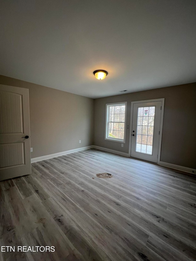 empty room with wood-type flooring