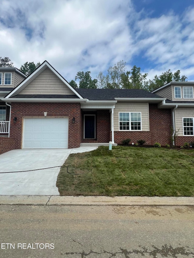 view of front facade featuring a garage and a front lawn