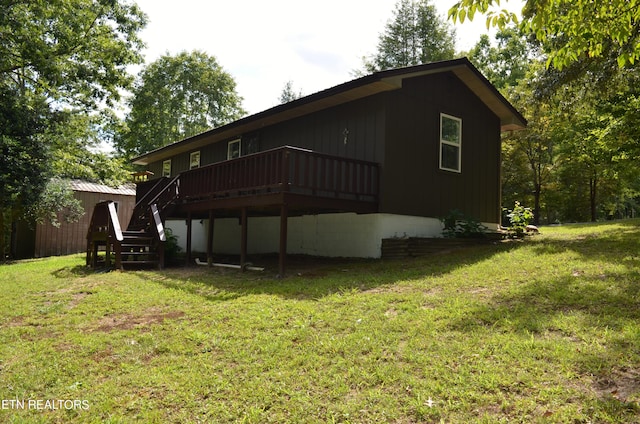 exterior space with a deck and a lawn