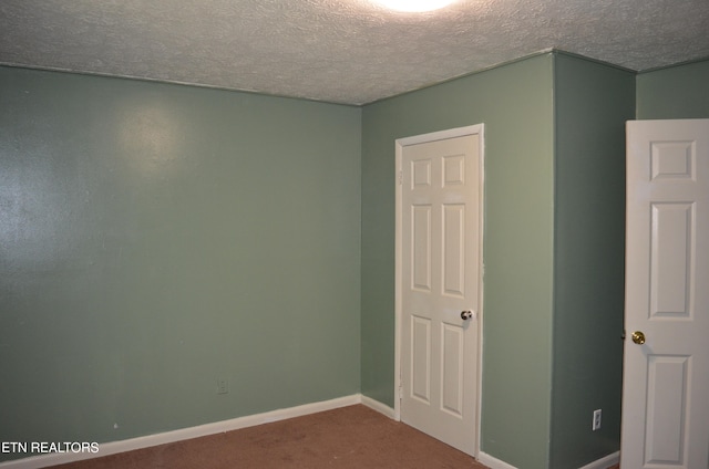 unfurnished bedroom with a textured ceiling and carpet