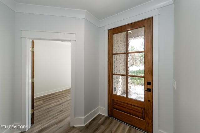 doorway to outside with crown molding and dark hardwood / wood-style floors