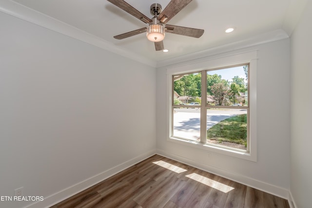 empty room with ornamental molding, hardwood / wood-style floors, and ceiling fan