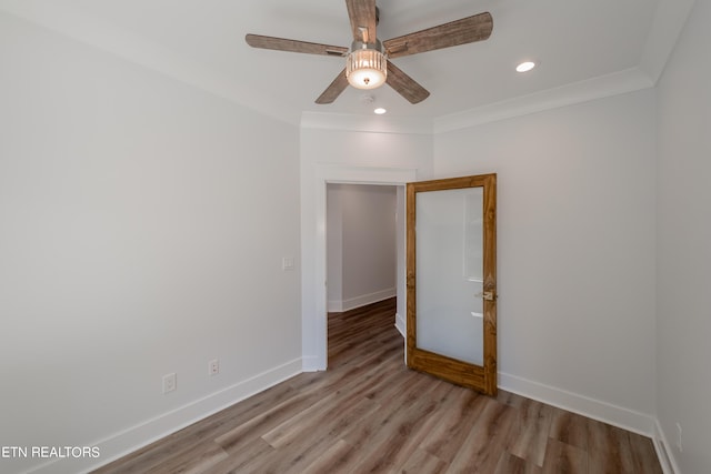 unfurnished room with crown molding, ceiling fan, and light hardwood / wood-style flooring