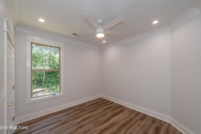 spare room featuring crown molding, ceiling fan, and dark hardwood / wood-style flooring