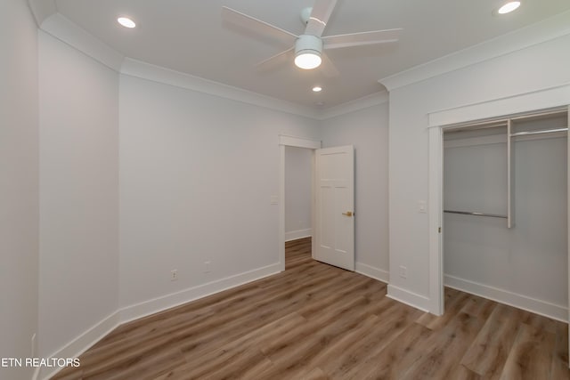 unfurnished bedroom featuring hardwood / wood-style floors, ornamental molding, a closet, and ceiling fan