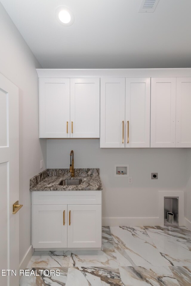 washroom with washer hookup, sink, cabinets, and hookup for an electric dryer