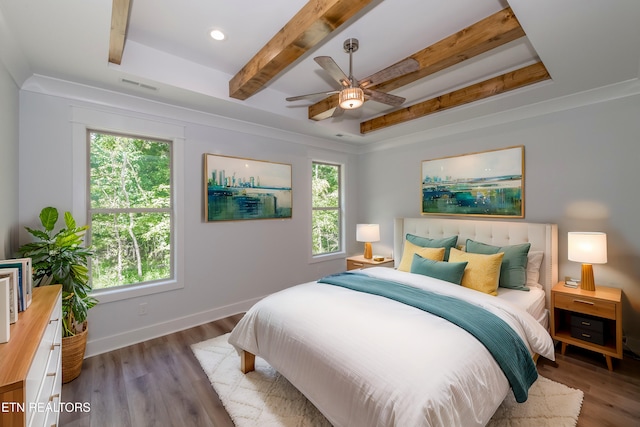 bedroom with ceiling fan, hardwood / wood-style flooring, and beamed ceiling