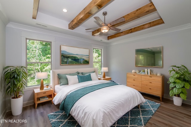 bedroom with dark wood-type flooring, multiple windows, and beamed ceiling