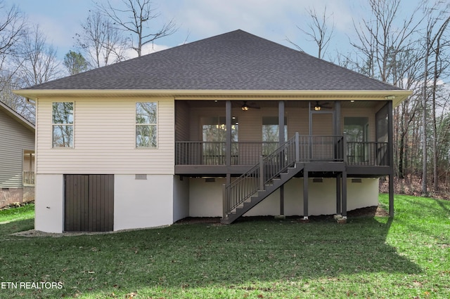 back of house featuring a yard, a sunroom, and ceiling fan