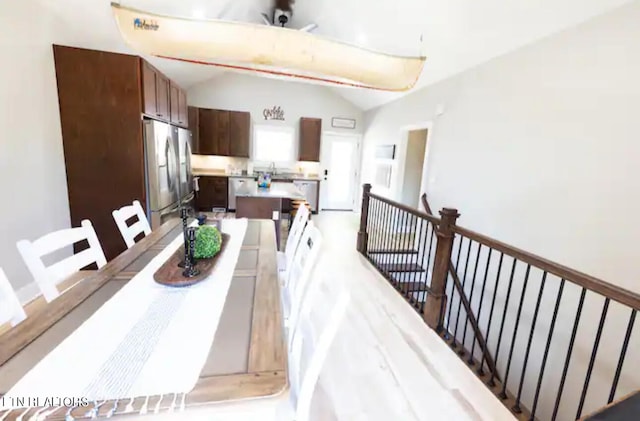 dining area with lofted ceiling and sink