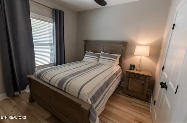 bedroom with ceiling fan and light wood-type flooring