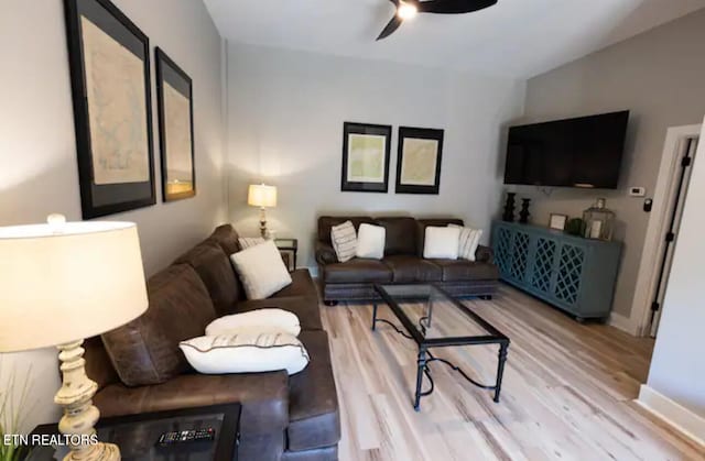 living room with ceiling fan and light hardwood / wood-style floors