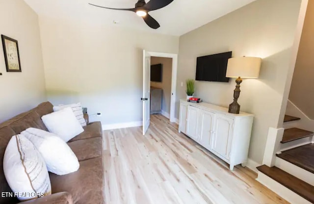 living room with ceiling fan and light hardwood / wood-style floors