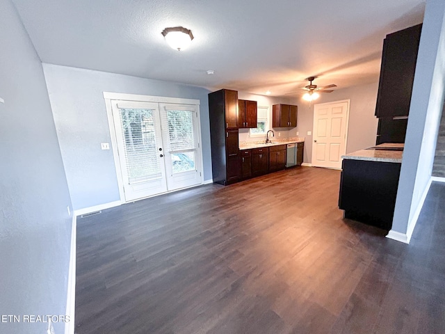 kitchen with ceiling fan, stainless steel dishwasher, dark hardwood / wood-style flooring, french doors, and dark brown cabinets