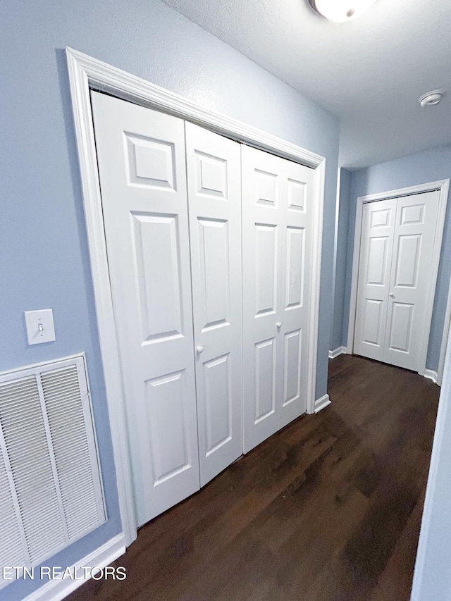 corridor featuring dark wood-type flooring