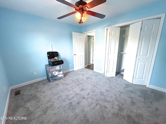 unfurnished bedroom featuring carpet flooring, ceiling fan, and a closet