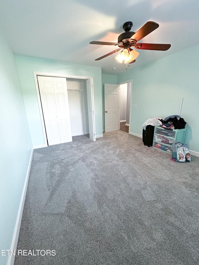 unfurnished bedroom with ceiling fan, a closet, and carpet floors