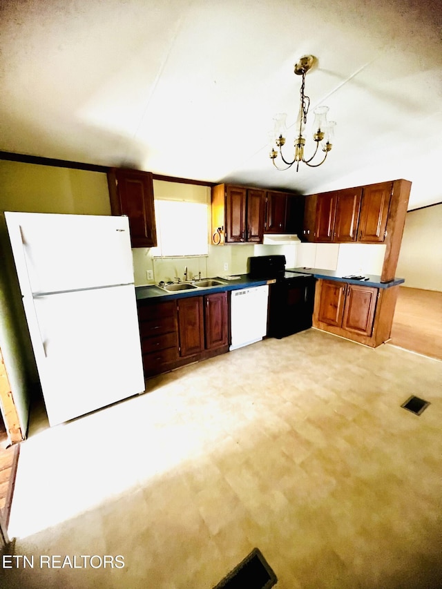 kitchen featuring white appliances, sink, pendant lighting, an inviting chandelier, and light colored carpet