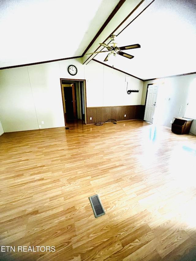 unfurnished living room featuring light hardwood / wood-style floors, vaulted ceiling with beams, and ceiling fan