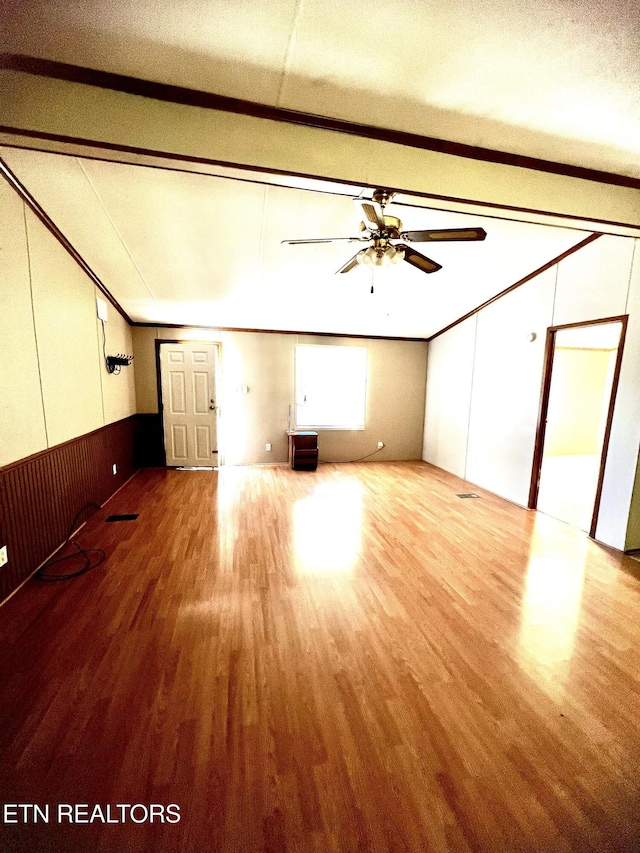 unfurnished living room with crown molding, a textured ceiling, light wood-type flooring, and ceiling fan