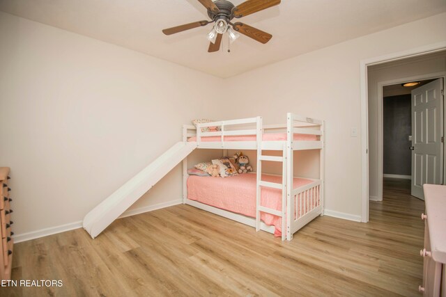 unfurnished bedroom with ceiling fan and light hardwood / wood-style flooring