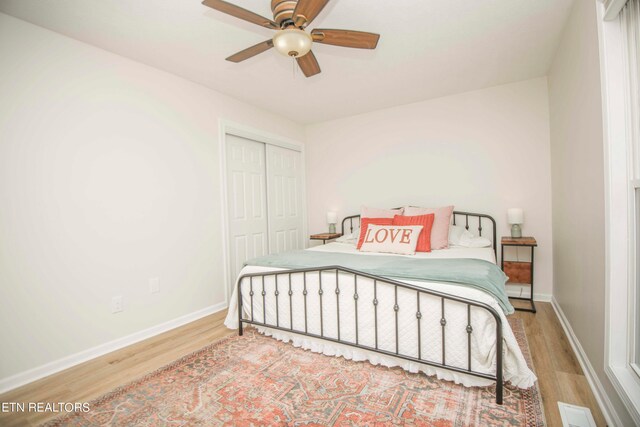 bedroom with ceiling fan, a closet, and light hardwood / wood-style floors