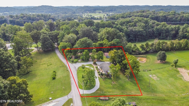 birds eye view of property with a rural view