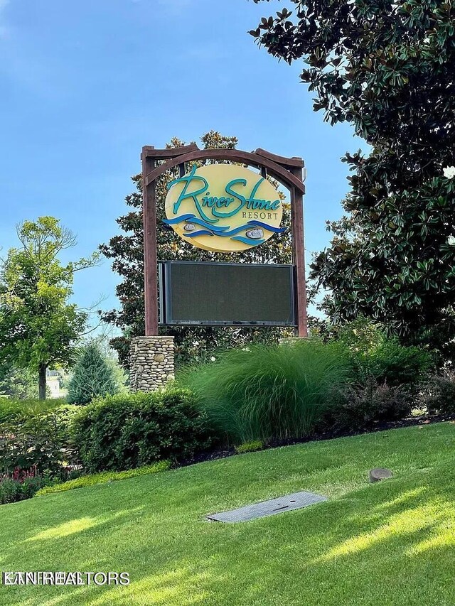 community / neighborhood sign with a lawn