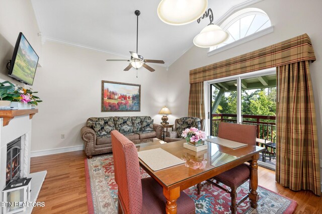 dining area with ceiling fan, crown molding, lofted ceiling, and light hardwood / wood-style floors