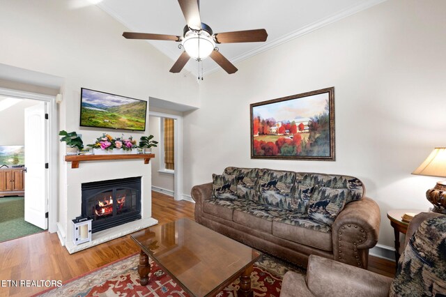 living room with ceiling fan, hardwood / wood-style flooring, and crown molding