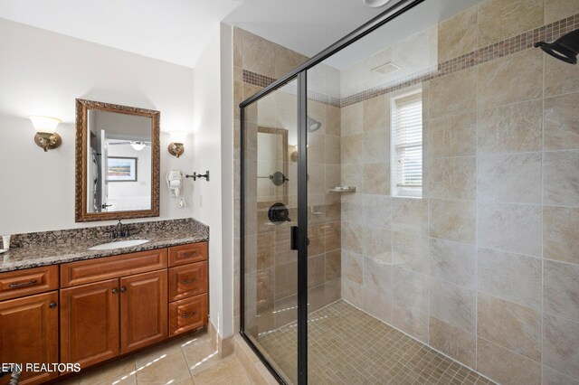 bathroom featuring an enclosed shower, vanity, and tile patterned floors